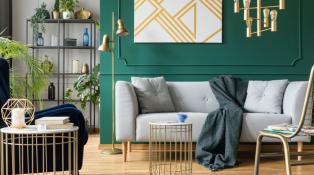 A hunter green accent wall compliments Bohemian chic-inspired furniture. 